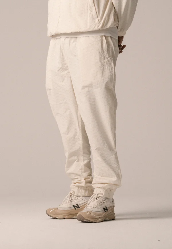 ALLOVER TRACK PANTS UNISEX - Jogginghose - antique white