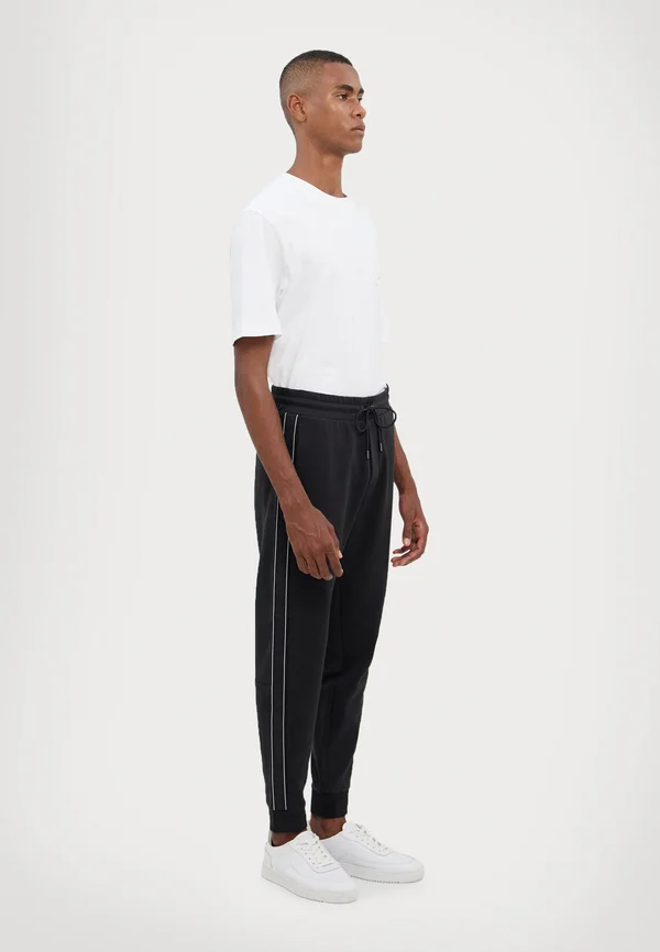 LOGO TAPE PANT - Jogginghose - black