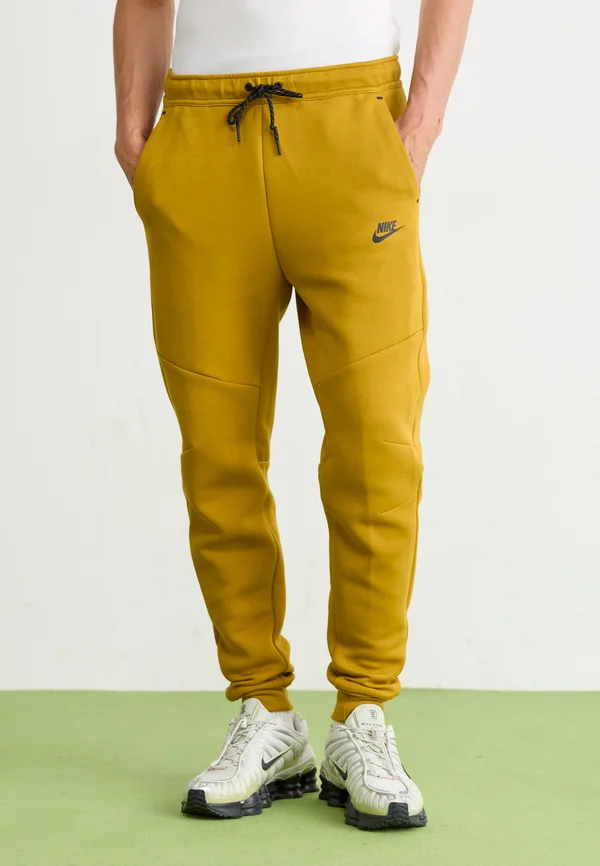 TECH FLEECE - Jogginghose - ochre black