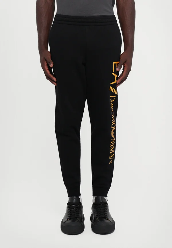 TRAIN LOGO SERIES PANTS - Jogginghose - black/gold coloured